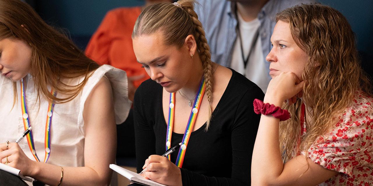 People concentrating and taking notes